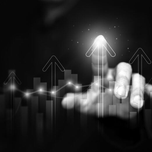 Finance, business, investment, or economy growing graph concept. A man tapping on top of an arrow, analyzed data, as it rising up high. The chart and arrows represening the growth and increase.